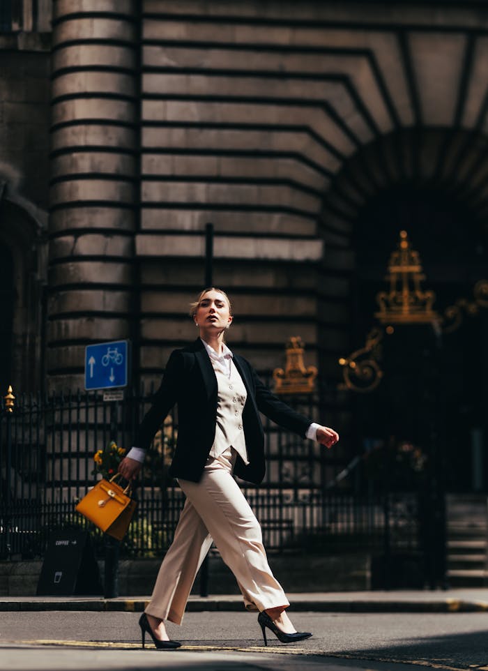 A woman in a suit walking down the street